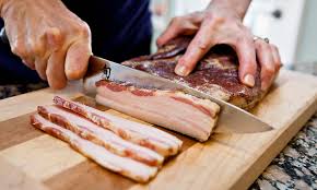 Hand slicing home made bacon