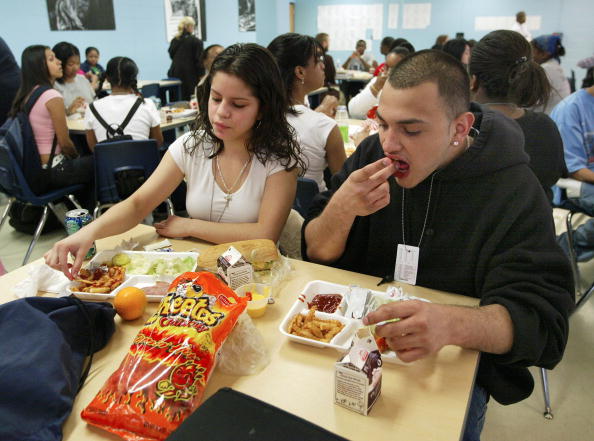 CHICAGO - APRIL 20:  Students eat lunch at Jones College Prep High School April 20, 2004 in Chicago, Illinois. The Chicago Public School system will introduce next fall a new vending policy restricting junk food and a new beverage contract banning carbonated drinks.  (Photo by Tim Boyle/Getty Images)